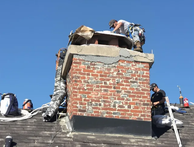 Uxbridge Chimney Sweep installing a custom chimney crown in Uxbridge, MA