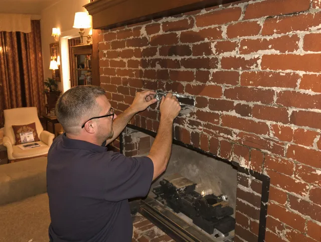 Uxbridge Chimney Sweep expert fixing a fireplace in Uxbridge, MA